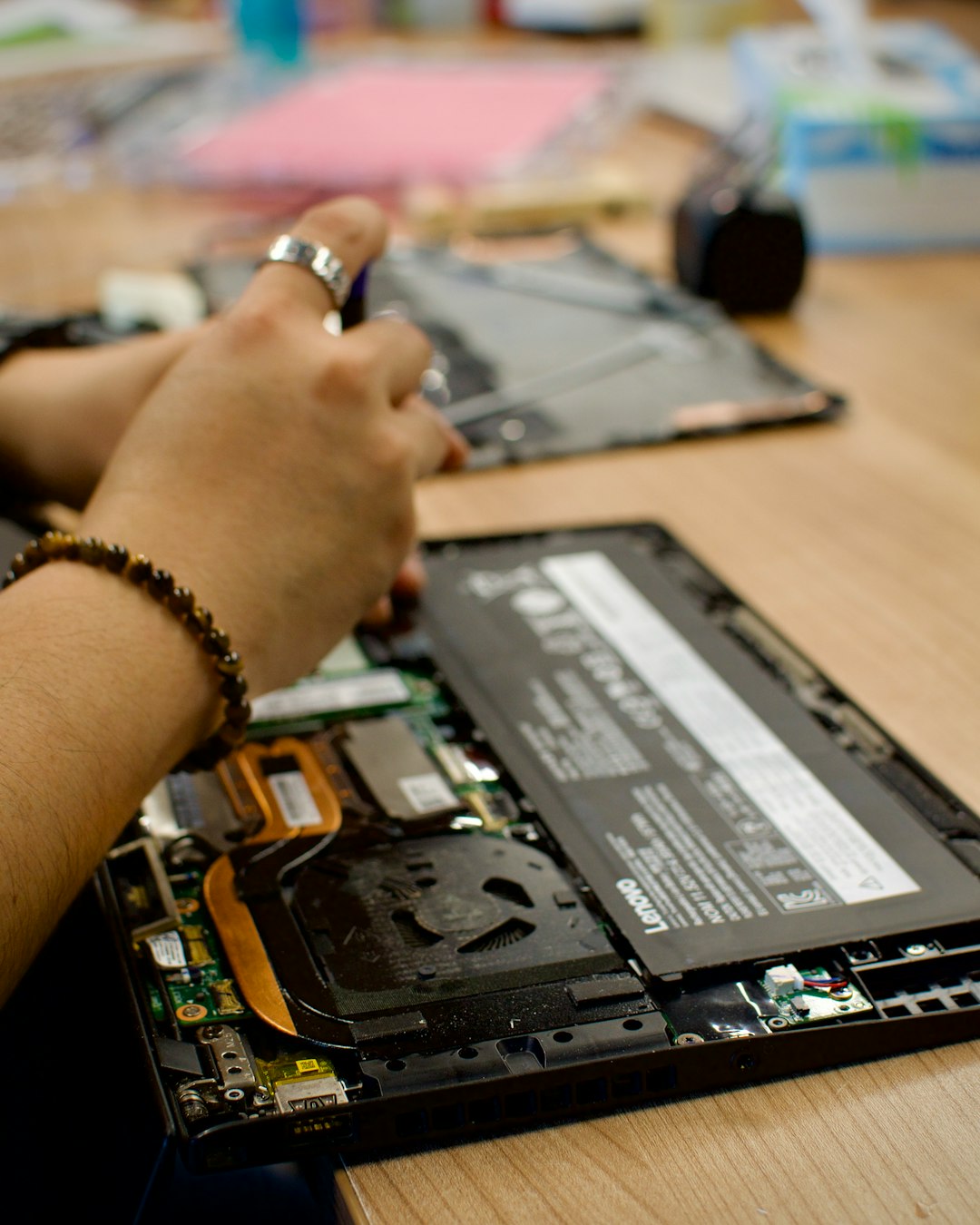 Man repairing laptop on the table at the office